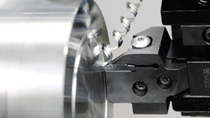 Image of KYOCERA's indexable face grooving tool and insert in action