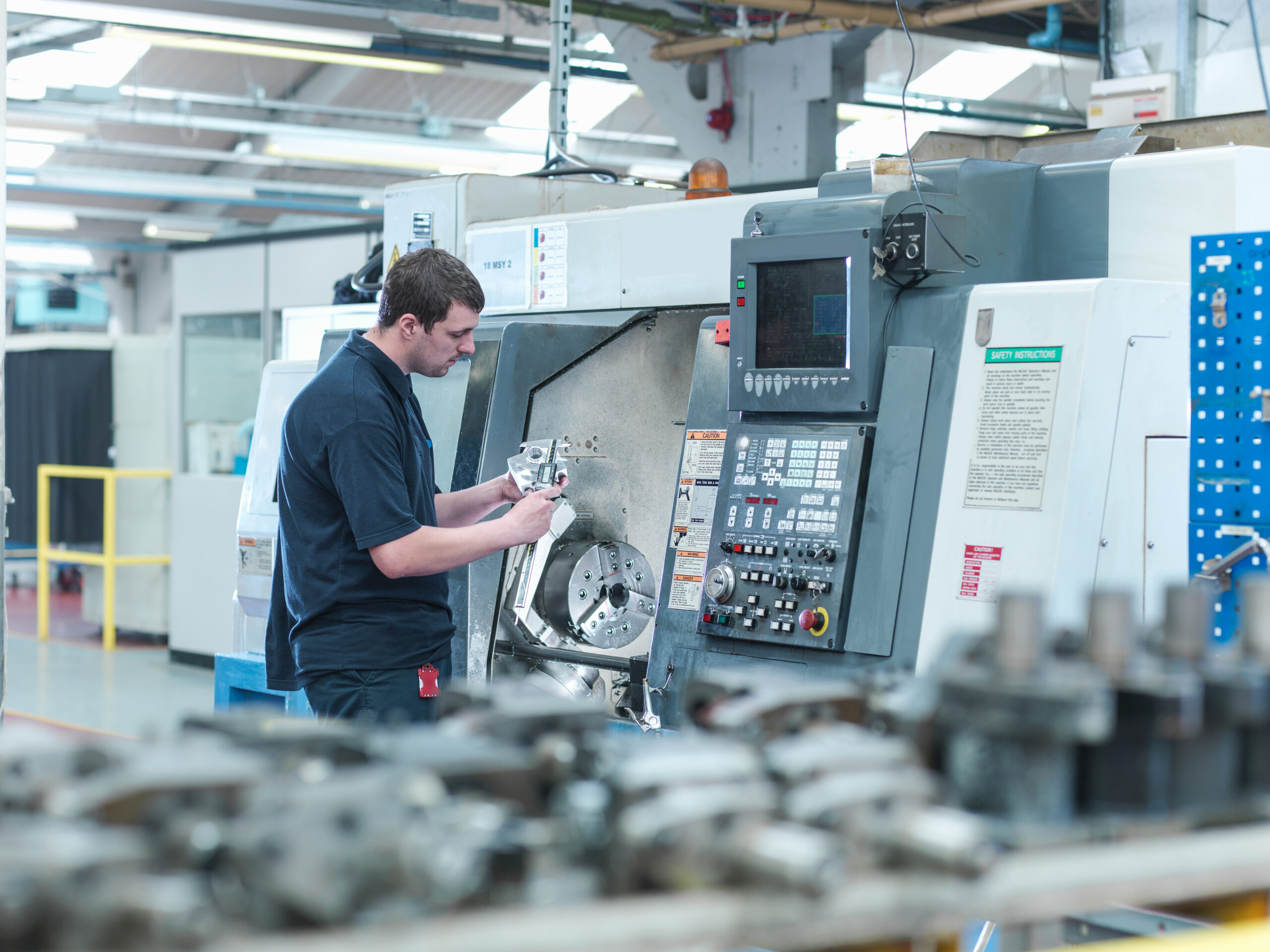 Machinist Inspecting Parts