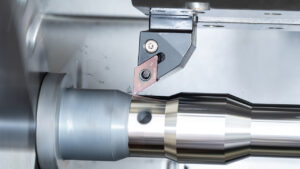 KYOCERA KBN015 CBN insert performing hard turning on steel, showing stable cutting action and smooth finish.